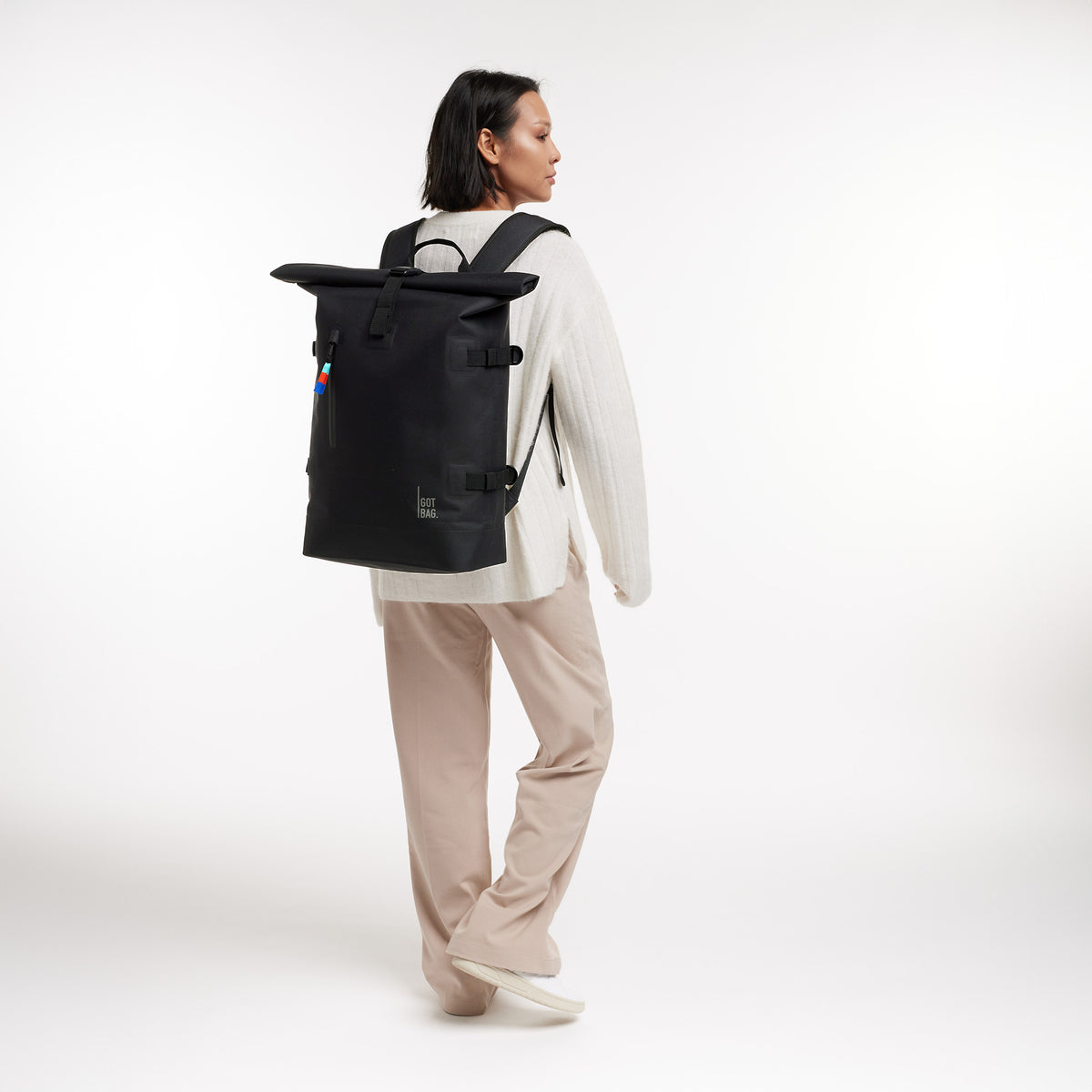 ROLLTOP 2.0 Rucksack in black (Schwarz) von einer Frau als Rucksack auf dem Rücken getragen.