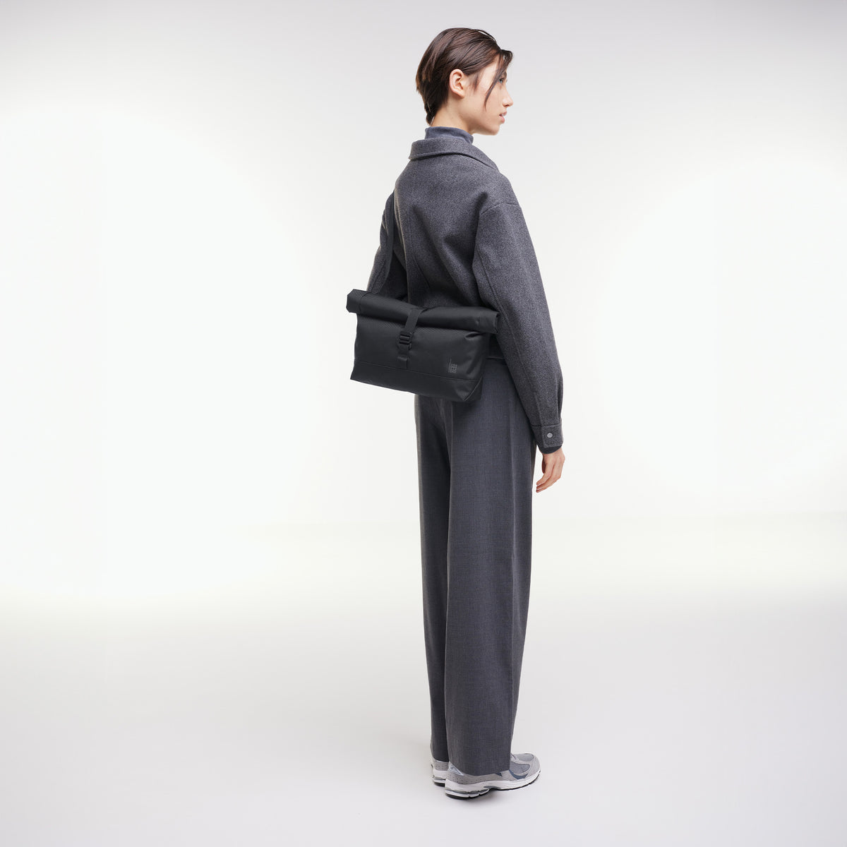 MESSENGER BAG Tasche in black (Schwarz) von einer Frau crossbody getragen.