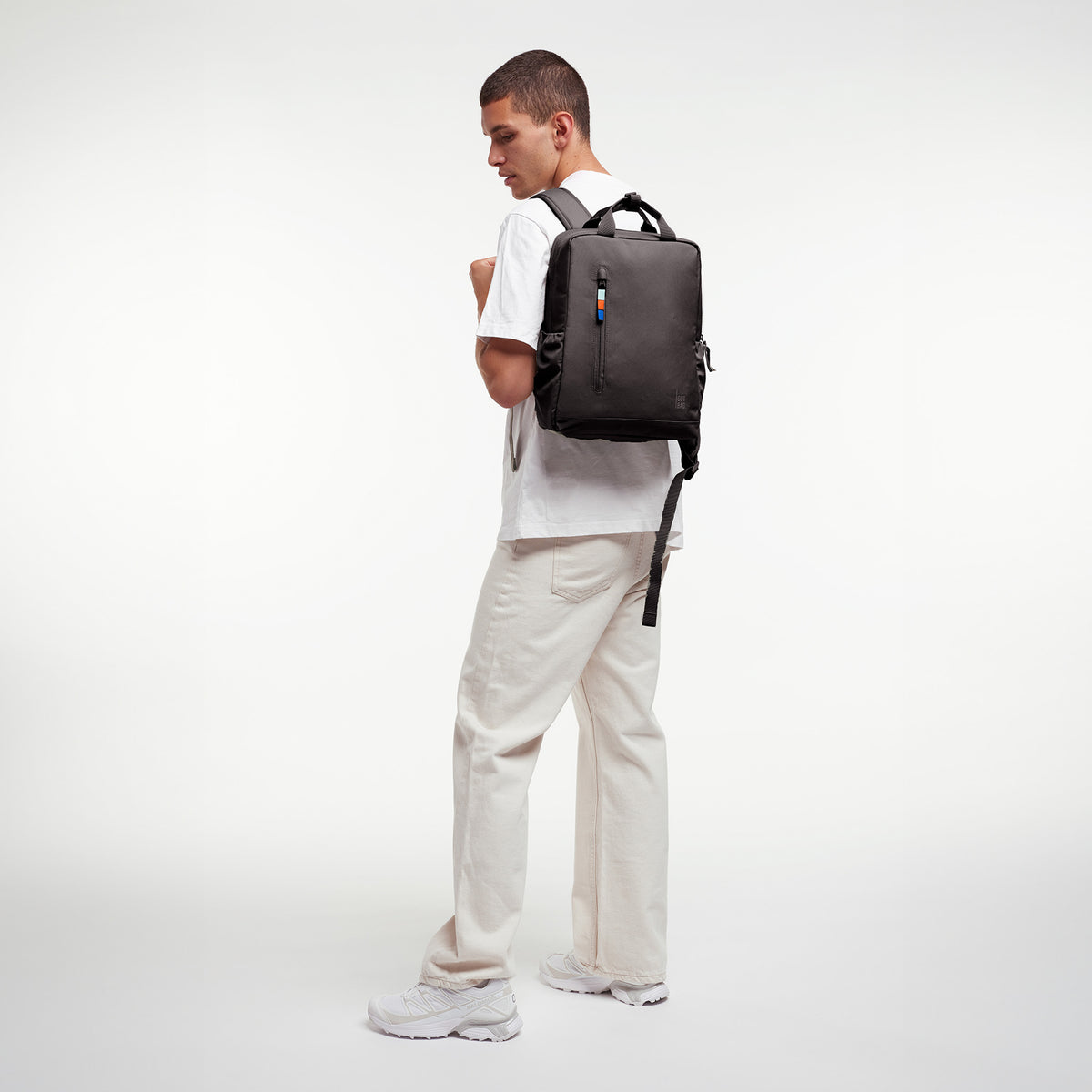 DAYPACK 2.0 Rucksack in mussel (dunkles Braun-Grau) von einem Mann als Rucksack auf dem Rücken getragen.