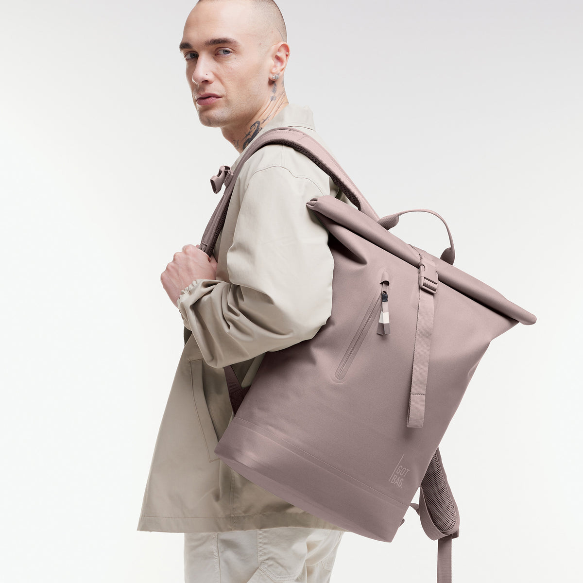 ROLLTOP LITE 2.0 Rucksack in blobfish (dunkles Altrosa) von einem Mann auf dem Rücken getragen.
