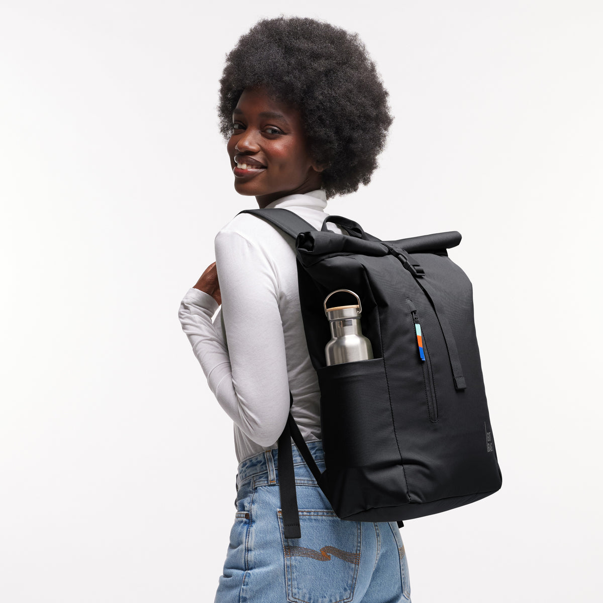 ROLLTOP EASY Rucksack in black (Schwarz) von einer Frau als Rucksack auf dem Rücken getragen.