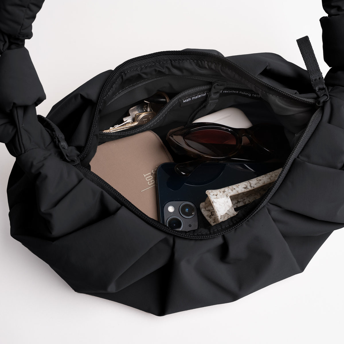 PLEAT MOON BAG SMALL Tasche in black (Schwarz) als Detailaufnahme des Innenraums.