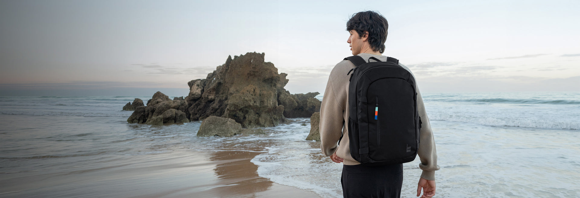 HYBRID PACK backpack in black (classic black) worn by a man on his back.