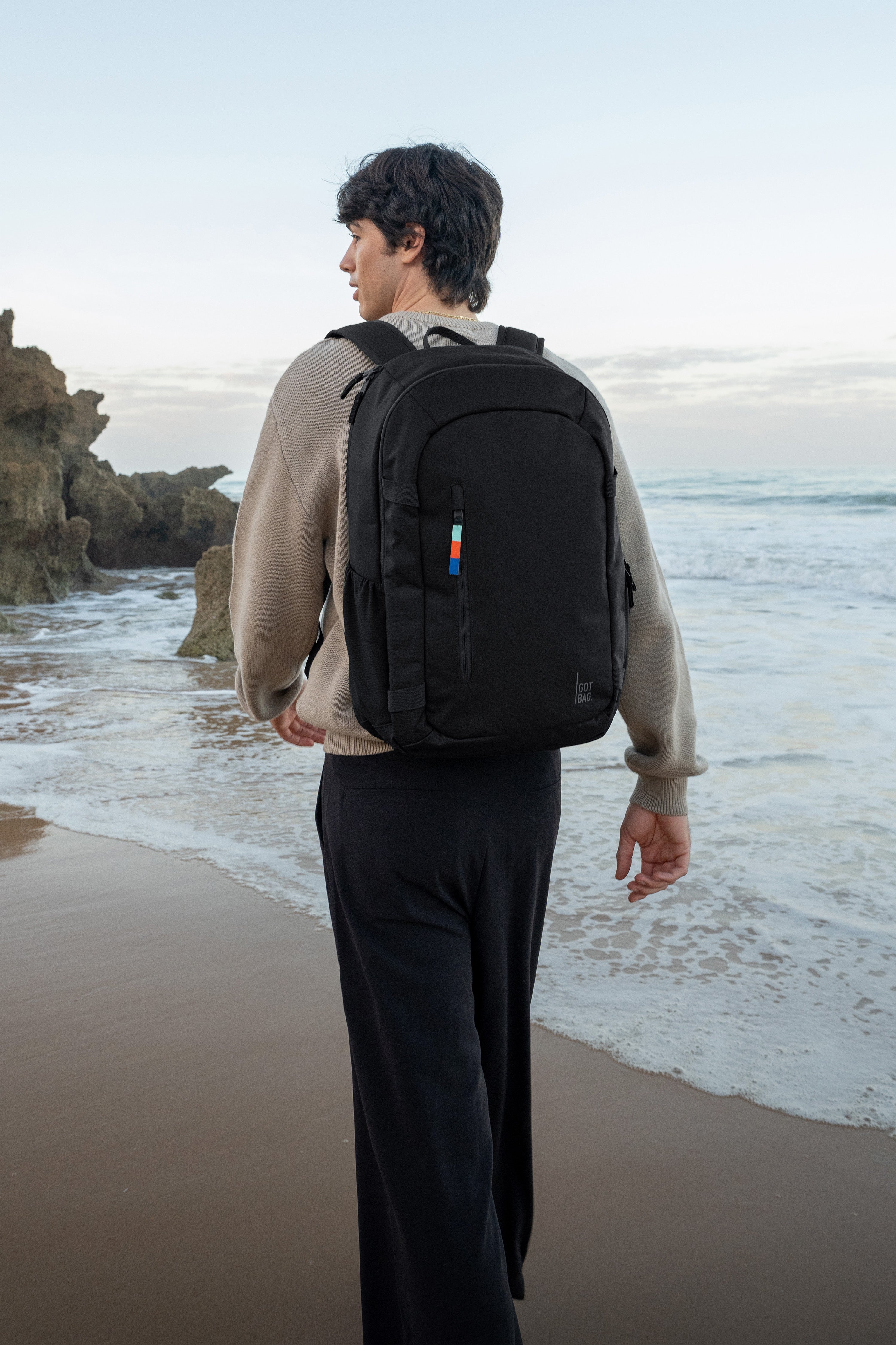 HYBRID PACK backpack in black (classic black) worn by a man on his back.