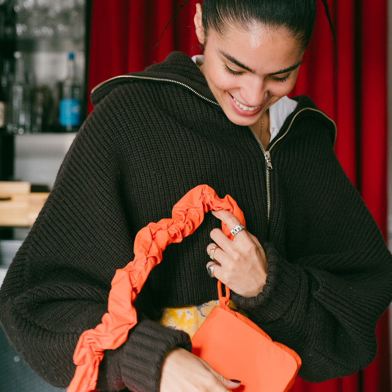 ESSENTIAL BAG bag held in hands by a woman.