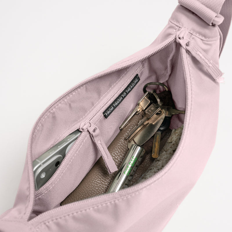 MOON BAG SMALL MONOCHROME Tasche in pink dolphin (blasses Hellrosa), Innenansicht gefüllt mit Handy und Schlüsseln.