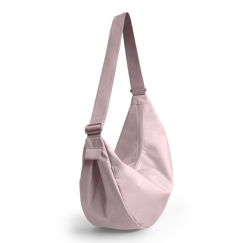 MOON BAG LARGE MONOCHROME Tasche in pink dolphin (blasses Hellrosa) als Studioaufnahme in diagonaler Ansicht.