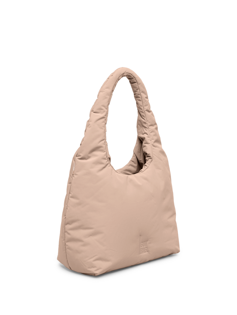 CLOUD SHOULDER BAG Tasche in sandbar (warmes Beige mit rötlichem Unterton) als Studioaufnahme in Schrägansicht.