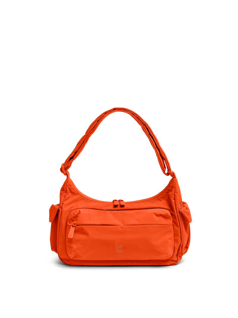 POCKETBAGSMALL bag in hot coral (vibrant orange) as a studio shot from the front.