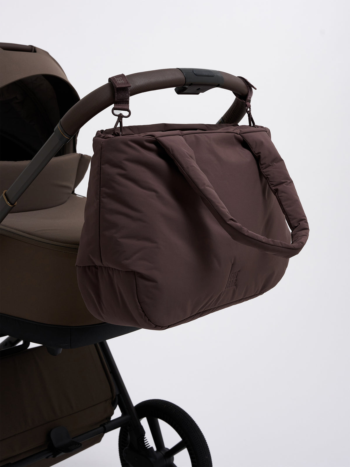 CLOUD HORIZON TOTE BAG Tasche in sea lion (dunkles Schokobraun) am Kinderwagen hängend.