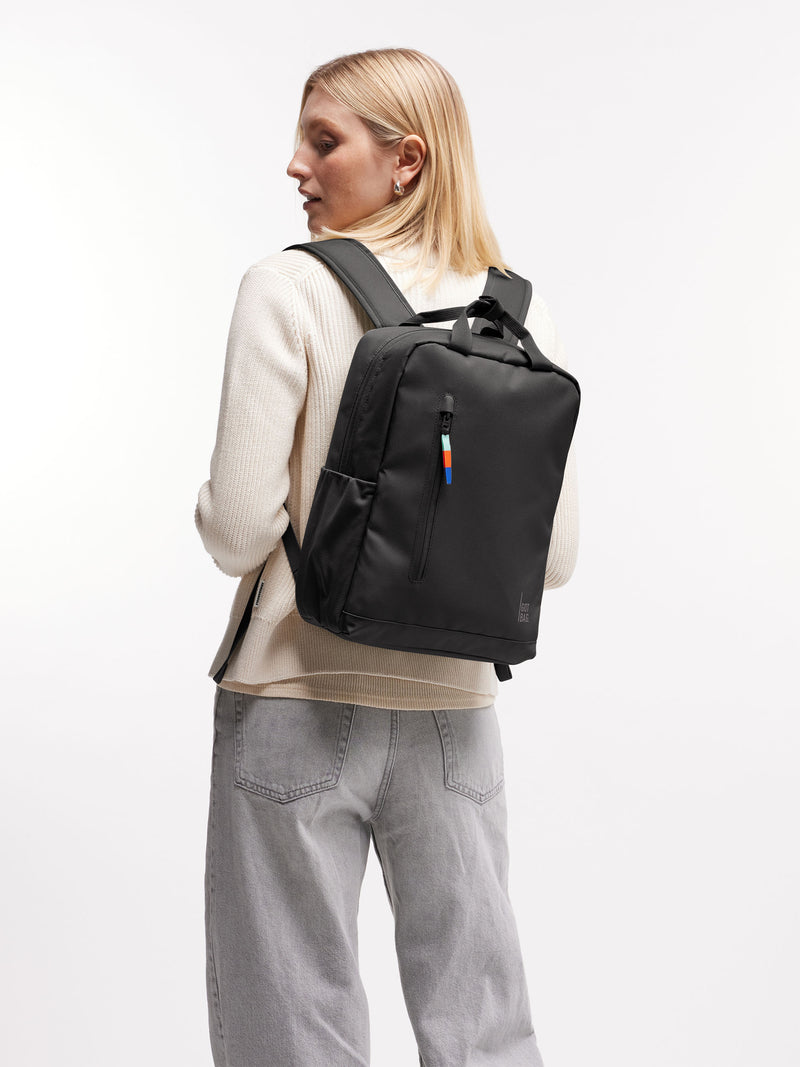 DAYPACK Rucksack in mussel (dunkles Braun-Grau) von einer Frau auf dem Rücken getragen.