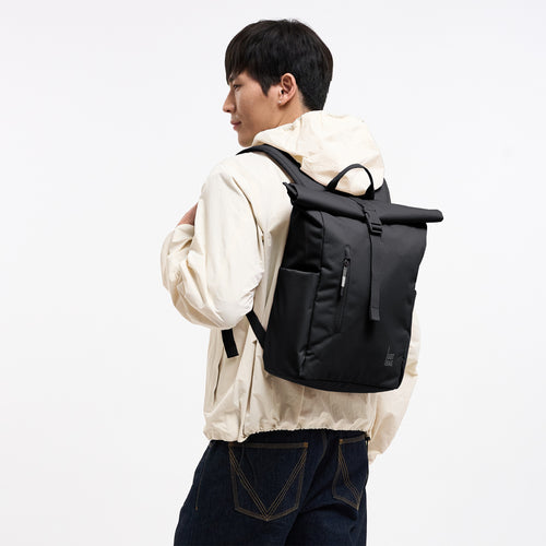 ROLLTOP EASY SMALL MONOCHROME Rucksack in black (Schwarz) von einem Mann auf dem Rücken getragen.