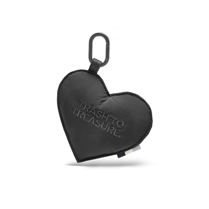 CHARM TREASURE doplňky v black (Černý). Srdíčkový přívěsek s karabinou a nápisem TRASH TO TREASURE, čelní pohled.