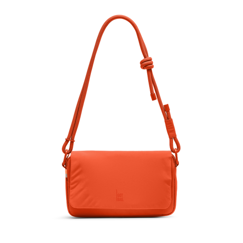 FACET BAG bag in hot coral (vibrant orange) as a studio shot in front view.