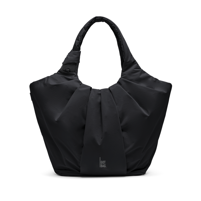 PLEAT TOTE BAG bolso en black (Negro) como toma de estudio en vista frontal.